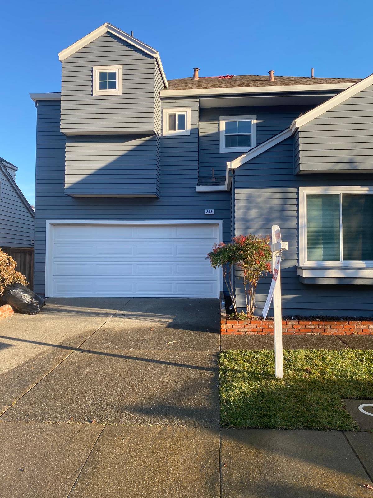Freshly painted gray residential exterior with white trim